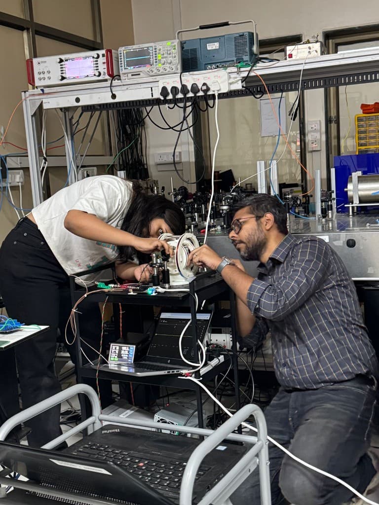 QuBeats team members collaborating on lab instrumentation